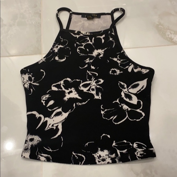 A black shirt with many white flowers - Picture 1 of 1